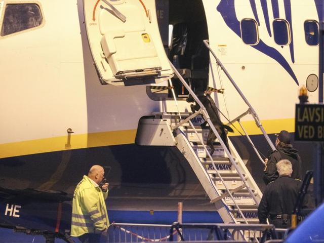 A police bomb officer stands in front of a Ryanair plane at Moss Airport Rygge, Norway. (AP)