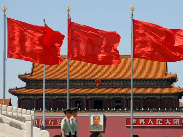 Paramilitary solders stand guard at Tiananmen Square where the portrait of late Chinese chairman Mao Zedong is seen, on the 50th anniversary of the start of the Cultural Revolution in Beijing, China. (Reuters Photo)