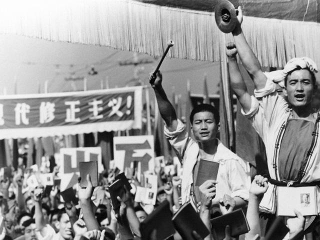 Drummers raise their cymbals and sticks as others hold up small booklets containing the writings of then chairman, Mao Zedong, during a demonstration by Red Guard youth groups in front of the Soviet Embassy in Beijing. (AP File Photo)