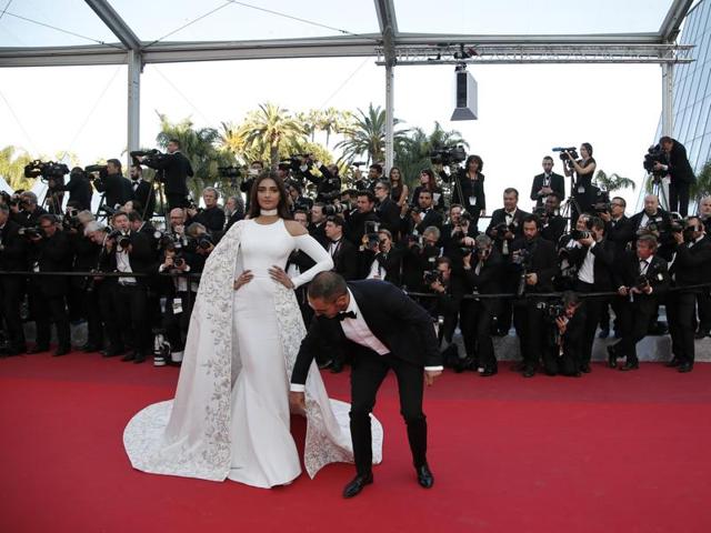 Sonam Kapoor has her dress adjusted as she poses for photographers upon arrival at the screening of the film Mal De Pierres at the 69th international film festival, Cannes. (AP) Sonam Kapoor has her dress adjusted as she poses for photographers upon arrival at the screening of the film Mal De Pierres at the 69th international film festival, Cannes. (AP)