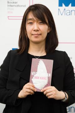 Korean author Han Kang poses for a photograph with her book The Vegetarian at a photocall in London on May 15, 2016. (AFP)