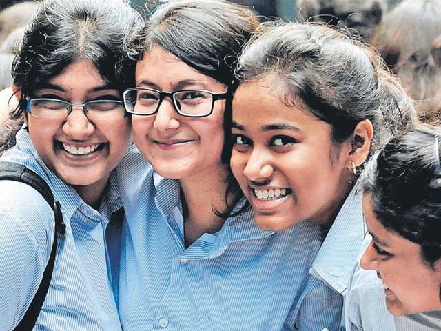 Students of South Point High School in Kolkata celebrate after the publication of the Higher Secondary examination results on Monday.(SUBHENDU GHOSH/HT)