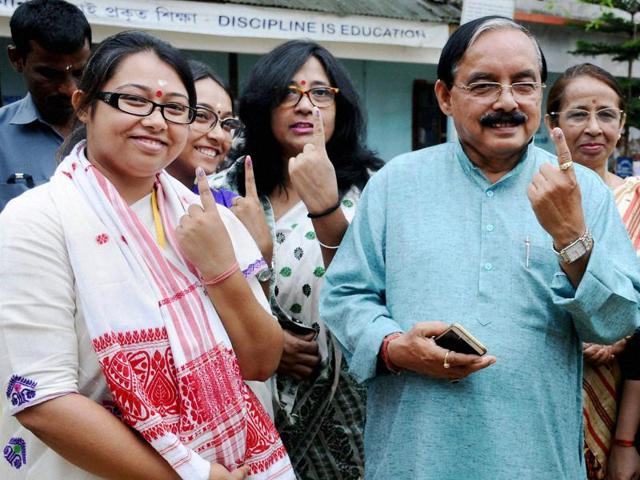 Assam Pradesh Congress Committee president Anjan Dutta with his daughter and Congress candidate from Amguri LAC Angkita Dutta, after casting their votes in Amguri. (PTI Photo)