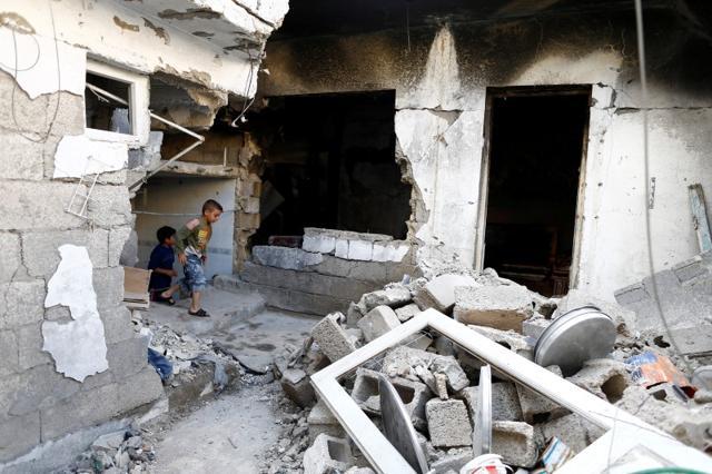 Children play inside a devastated house that was struck by rocket fire from Syria in Turkey's southeastern border town of Kilis. (Reuters) Children play inside a devastated house that was struck by rocket fire from Syria in Turkey's southeastern border town of Kilis. (Reuters)