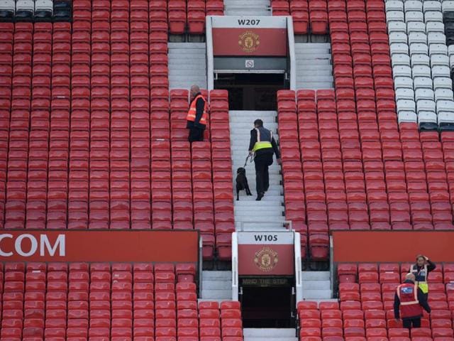 A sniffer dog searches the stands after fans evacuated Old Trafford stadium in Manchester, on May 15, 2016, after the Premier League match between Manchester United and Bournemouth was abandoned. (AFP) A sniffer dog searches the stands after fans evacuated Old Trafford stadium in Manchester, on May 15, 2016, after the Premier League match between Manchester United and Bournemouth was abandoned. (AFP)