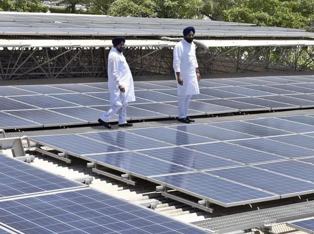 Renewable energy minister Bikram Singh Majithia (right) inspecting the rooftop solar power plant installed at Dera Baba Jaimal Singh, by the Radha Soami sect at Beas, 45km from Amritsar, after it was inaugurated by CM Parkash Singh Badal on Tuesday.(Gurpreet Singh/HT Photo)