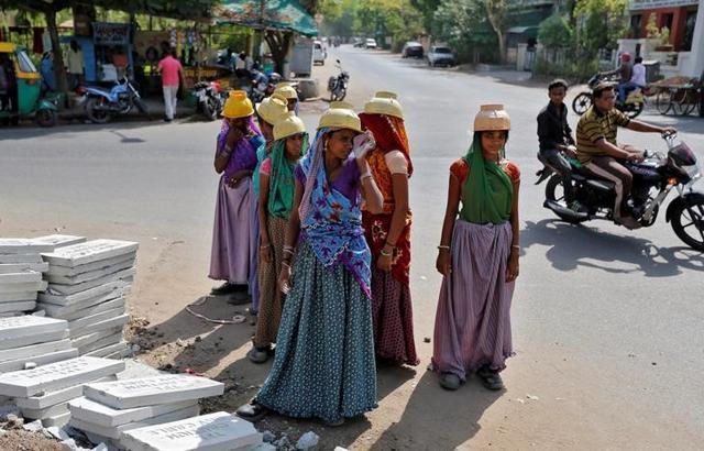 Sarta Kalara (centre), a construction worker, stands among other female workers in Ahmedabad. (Reuters) Sarta Kalara (centre), a construction worker, stands among other female workers in Ahmedabad. (Reuters)