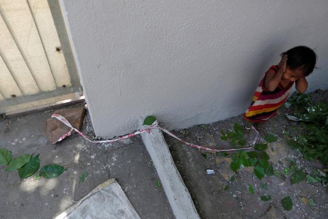 Fifteen-month-old Shivani plays as barrier tape is tied around her ankle to prevent her from running away. (Reuters) Fifteen-month-old Shivani plays as barrier tape is tied around her ankle to prevent her from running away. (Reuters)