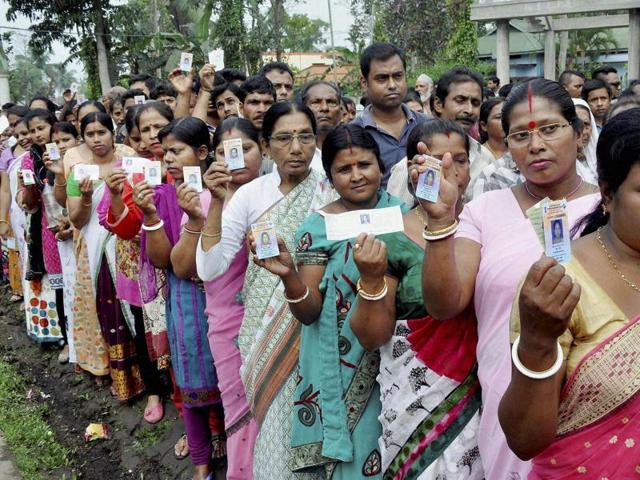 Voters queueing up outside a polling booth during the first phase of Assam assembly elections 2016 at Gormur. (PTI Photo)