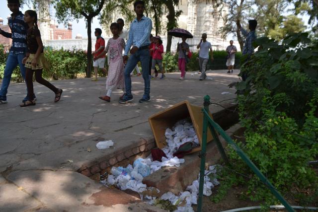 A wastepaper bin lies overturned even as tourists walk past, on the Taj Mahal premises. (Raju Tomar/ HT Photo) A wastepaper bin lies overturned even as tourists walk past, on the Taj Mahal premises. (Raju Tomar/ HT Photo)