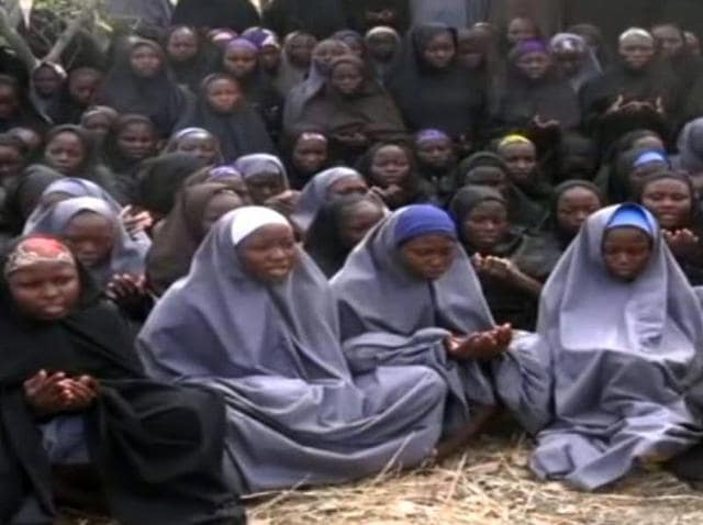 (FILES) This file photo taken on May 12, 2014 shows a screengrab taken from a video of Nigerian Islamist extremist group Boko Haram obtained by AFP showing girls, wearing the full-length hijab and praying in an undisclosed rural location. (AFP) (FILES) This file photo taken on May 12, 2014 shows a screengrab taken from a video of Nigerian Islamist extremist group Boko Haram obtained by AFP showing girls, wearing the full-length hijab and praying in an undisclosed rural location. (AFP)