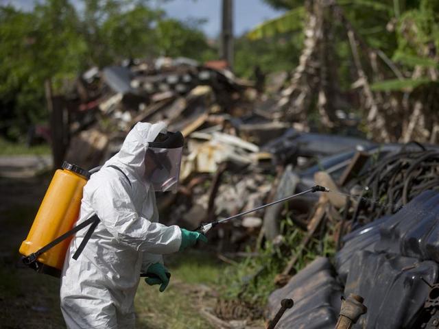 A municipal health worker sprays insecticide in a junkyard to combat the Aedes aegypti mosquito that transmits the Zika virus, in Joao Pessoa, Brazil.(AP file photo)