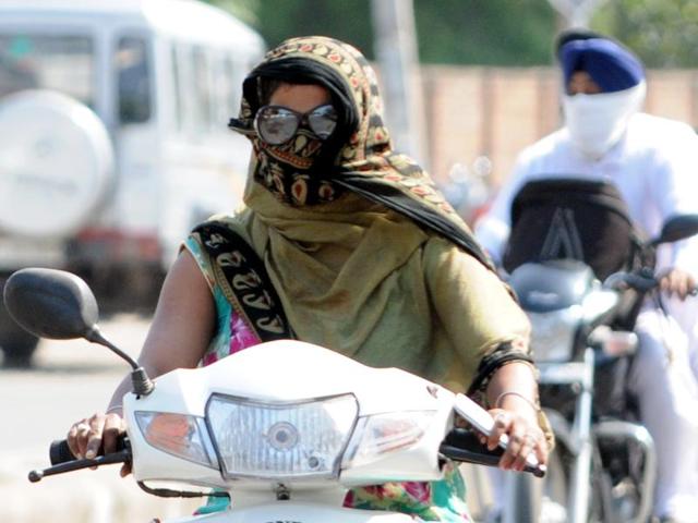 Commuters cover their faces to protect against the heat, in Patiala. (Bharat Bhushan/HT Photo) Commuters cover their faces to protect against the heat, in Patiala. (Bharat Bhushan/HT Photo)