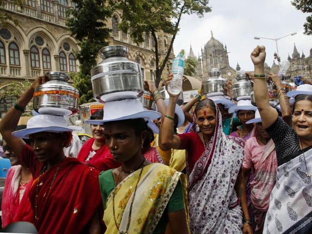 Women carry water pots on their heads to during protest in Mumbai on Tuesday. Dozens of protestors who were protesting against the water crisis in the suburban Thane and Shahapur districts from villages had arrived in the city walking for over three days. (AP) Women carry water pots on their heads to during protest in Mumbai on Tuesday. Dozens of protestors who were protesting against the water crisis in the suburban Thane and Shahapur districts from villages had arrived in the city walking for over three days. (AP)