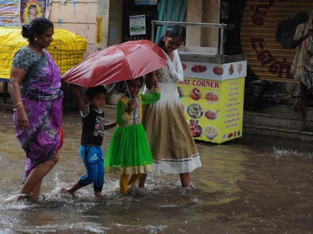 A woman walks under an umbrella amid heavy rains at Patinapakkam in Chennai on May 17, 2016.(AFP) A woman walks under an umbrella amid heavy rains at Patinapakkam in Chennai on May 17, 2016.(AFP)