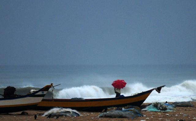 A man walks under an umbrella amid heavy rains at Marina Beach in Chennai on May 17, 2016. (AFP) A man walks under an umbrella amid heavy rains at Marina Beach in Chennai on May 17, 2016. (AFP)