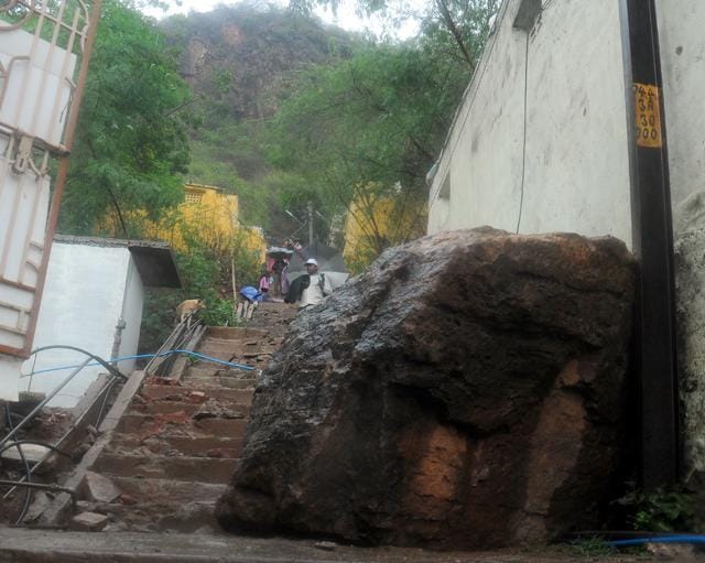 Boulders rolled down from a hill due to heavy rainfall at Chandra Rajeswara Rao Nagar, in Vijayawada on Thursday. (Mastan Babu/HT Photo)