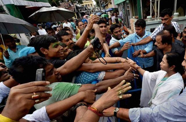 West Bengal CM Mamata Banerjee shaking hands with supporters after her party’s thumping win. (PTI Photo) West Bengal CM Mamata Banerjee shaking hands with supporters after her party’s thumping win. (PTI Photo)