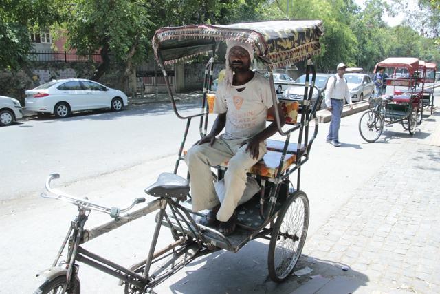 Rickshaw puller Rajesh Kumar Yadav has decided to leave for his village soon, as earnings are sparse. (Shivam Saxena/HT)