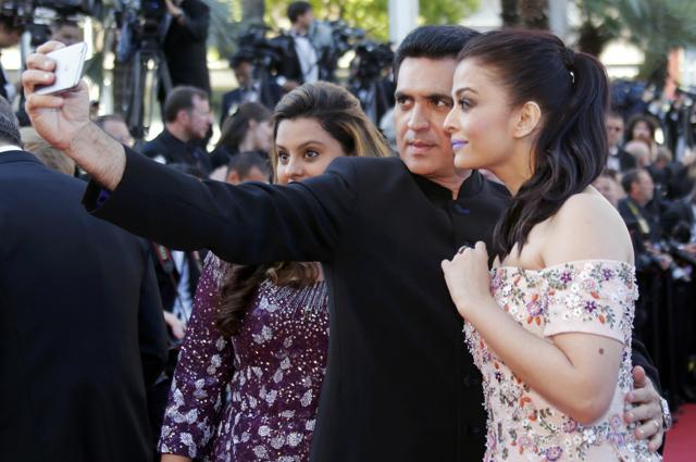 Aishwarya Rai (R) takes a selfie as she poses on the red carpet. (REUTERS) Aishwarya Rai (R) takes a selfie as she poses on the red carpet. (REUTERS)