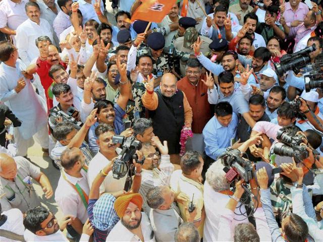 BJP President Amit Shah is welcomed by the party workers as he arrives at the party office in New Delhi on Thursday to address the media following the results of Assembly elections in the five states.  (PTI) 