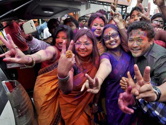 BJP workers dance as they celebrate their win in Assam Assembly election 2016 at Hengrabari in Guwahati on Thursday. (PTI)