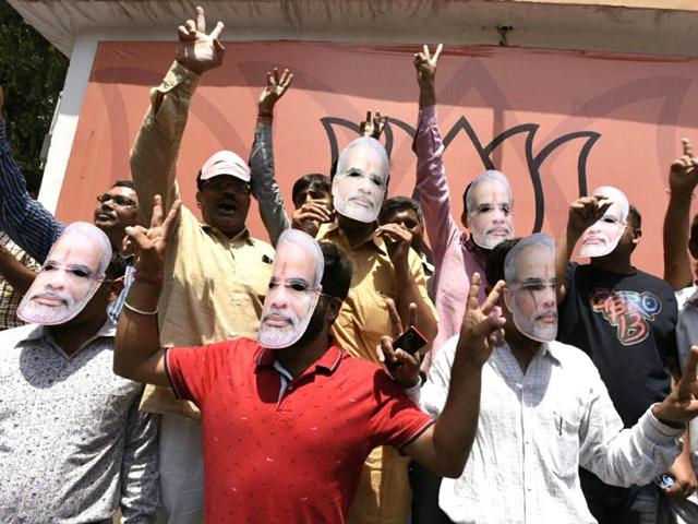 BJP party workers celebrate after winning Assam Assembly election in New Delhi on Thursday. (Photo by Sonu Mehta/ Hindustan Times)