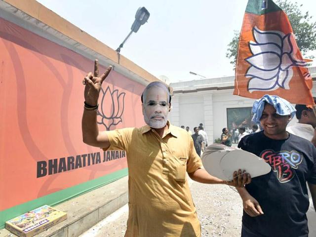 BJP activists celebrate after winning Assam Assembly election in New Delhi, India on Thursday. (Photo by Sonu Mehta/ Hindustan Times)