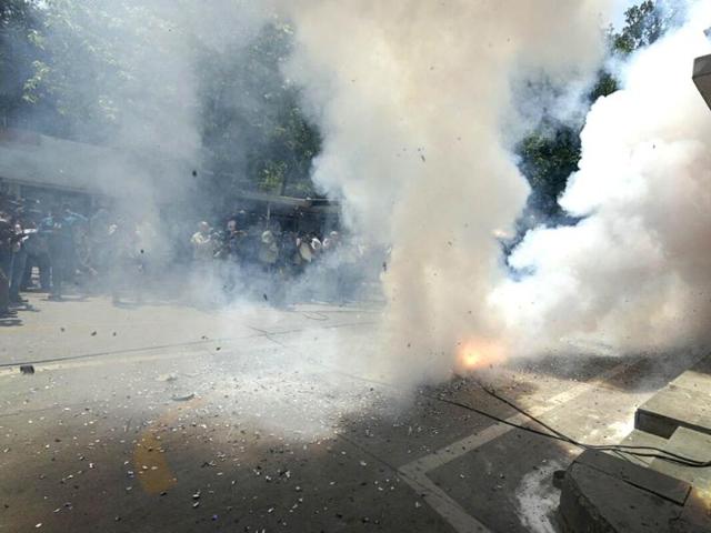BJP activists burst crackers to celebrate after winning Assam Assembly election in New Delhi. (Photo by Sonu Mehta/ Hindustan Times)