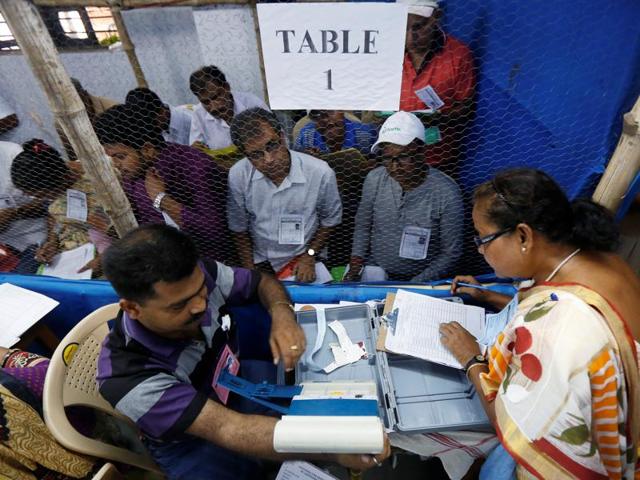 Election officials count votes in the West Bengal Assembly elections, at a counting centre in Kolkata. (REUTERS)