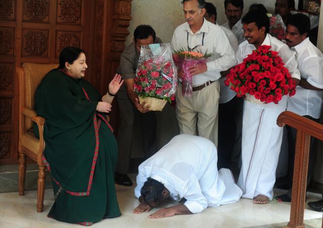 A party cadre prostrates himself at the feet of AIADMK leader Jayalalithaa Jayaram as she gestures at her residence in Chennai. (AFP) A party cadre prostrates himself at the feet of AIADMK leader Jayalalithaa Jayaram as she gestures at her residence in Chennai. (AFP)