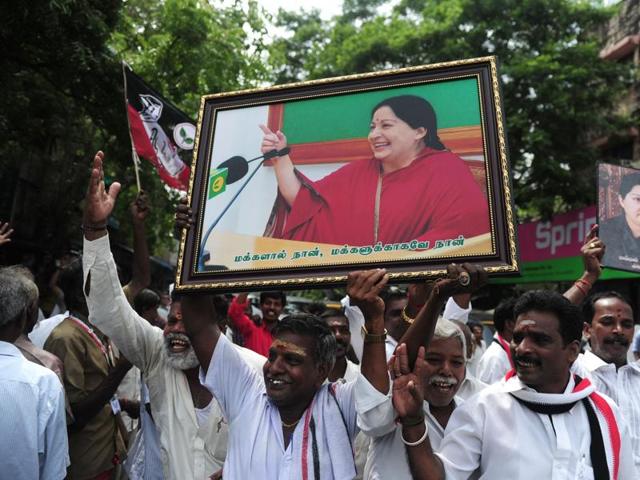 AIADMK members carry placards with the image of Jayalalithaa as they celebrate in front of her residence in Chennai . (AFP) AIADMK members carry placards with the image of Jayalalithaa as they celebrate in front of her residence in Chennai . (AFP)