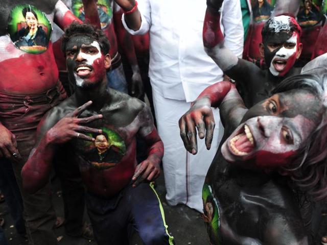 Members of the All India Anna Dravida Munnetra Kazhagam(AIADMK) party display the image of AIADMK leader Jayalalithaa Jayaram painted on their bodies as they celebrate in front of her residence in Chennai on May 19, 2016. (AFP)