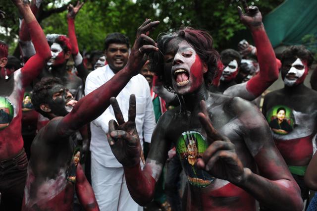 Members of the All India Anna Dravida Munnetra Kazhagam(AIADMK) party display the image of J Jayalalithaa painted on their bodies as they celebrate in front of her residence in Chennai on May 19. (AFP) Members of the All India Anna Dravida Munnetra Kazhagam(AIADMK) party display the image of J Jayalalithaa painted on their bodies as they celebrate in front of her residence in Chennai on May 19. (AFP)