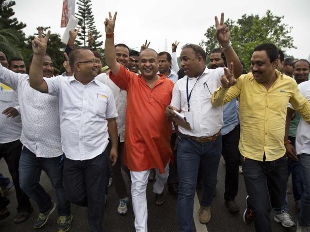 Bharatiya Janata Party (BJP) candidate Himanta Biswa Sharma, center in orange color shirt, celebrates with his supporters after wining in Assam state election in Guwahati. (AP) 
