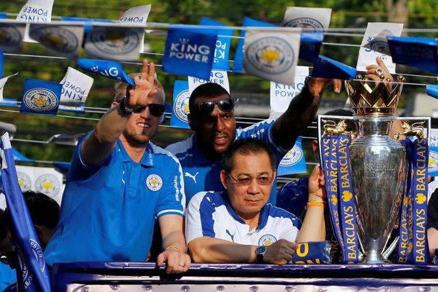 Kasper Schmeichel, left, and Wes Morgan, centre, enjoy the parade. (REUTERS) Kasper Schmeichel, left, and Wes Morgan, centre, enjoy the parade. (REUTERS)