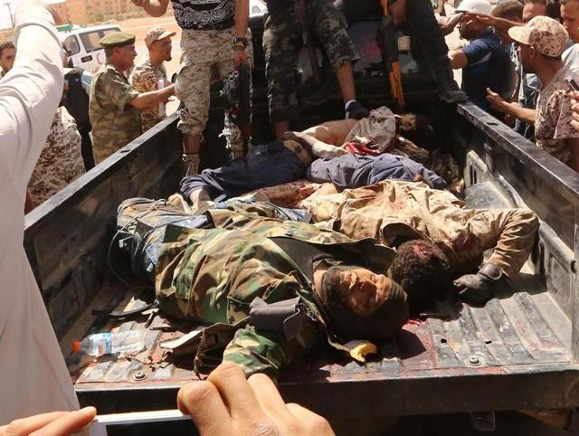 Libyan pro-government forces and onlookers gather around the bodies of reported fighters of the Islamic State (IS) group on a truck on Wednesday in Abu Grein, south of Libya's Misrata, a day after Libya's unity government recaptured the area from IS. (AFP) Libyan pro-government forces and onlookers gather around the bodies of reported fighters of the Islamic State (IS) group on a truck on Wednesday in Abu Grein, south of Libya's Misrata, a day after Libya's unity government recaptured the area from IS. (AFP)