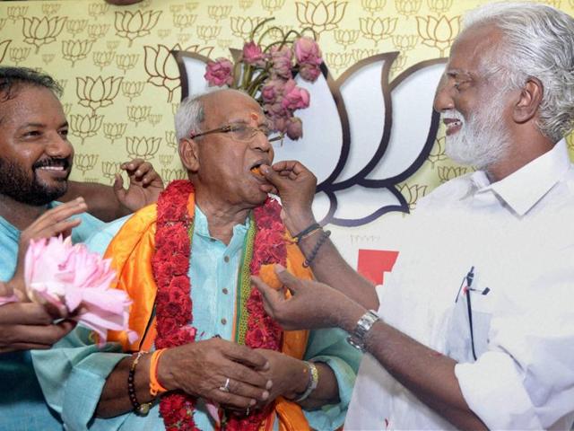BJP's only winning candidate from Nemom constituency in Kerala, O Rajagopal is offered sweets by party leaders in Thiruvananthapuram. (PTI) 