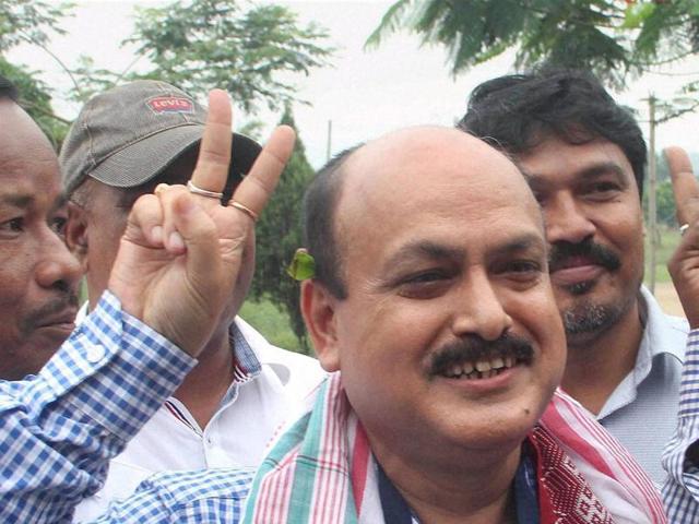 AGP candidate Ramendra Narayan Kalita makes a victory sign as he visits a counting centre for Assembly polls in Guwahati on Thursday. (PTI)