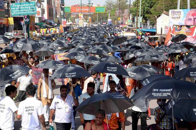 Devotees holding umbrellas to beat scorching heat during Simhastha Mahakumbh Mela, in Ujjain. (PTI) Devotees holding umbrellas to beat scorching heat during Simhastha Mahakumbh Mela, in Ujjain. (PTI)