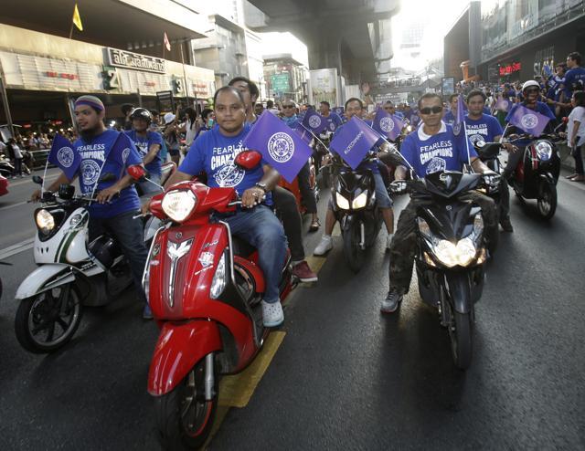 Thai football fans ride motorcycles as they cheer Leicester City’s parade. (AP) Thai football fans ride motorcycles as they cheer Leicester City’s parade. (AP)