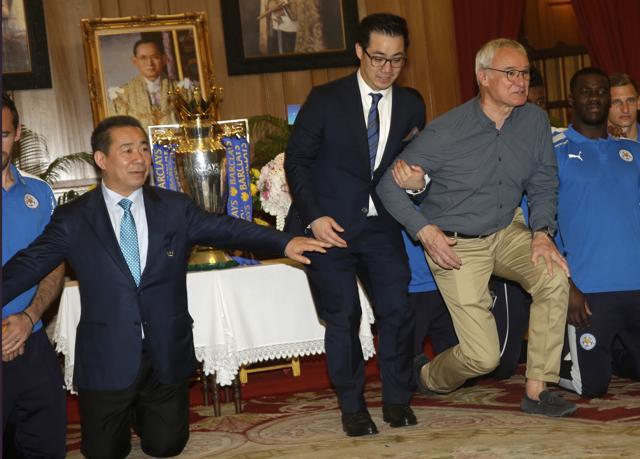 Leicester City chairman Vichai Srivaddhanaprabha, left , vice chairman Aiyawatt Srivaddhanaprabha, center, and manager Claudio Ranieri, stand up after paying respect to the image of Thai King Bhumibol Adulyadej at Grand palace in Bangkok. (AP) Leicester City chairman Vichai Srivaddhanaprabha, left , vice chairman Aiyawatt Srivaddhanaprabha, center, and manager Claudio Ranieri, stand up after paying respect to the image of Thai King Bhumibol Adulyadej at Grand palace in Bangkok. (AP)