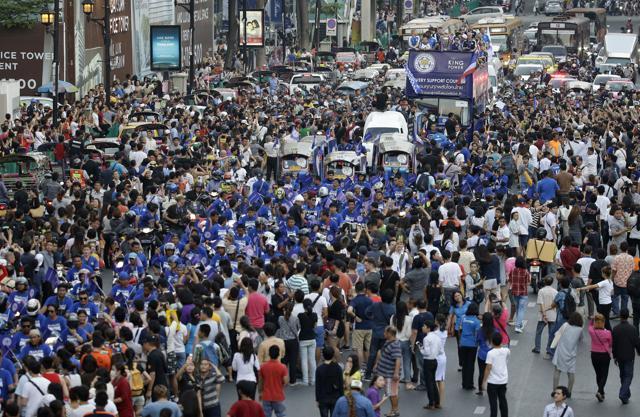 Crowds line the street to cheer on Leicester City players and staff celebrating their Premier League win with a procession on an open-top bus. (AP) Crowds line the street to cheer on Leicester City players and staff celebrating their Premier League win with a procession on an open-top bus. (AP)
