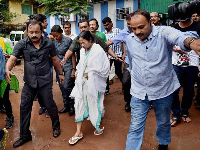 Escorted by her security personnel, West Bengal CM Mamata Banerjee walks out of her residence after her party's thumping win in West Bengal Assembly elections. (PTI ) 