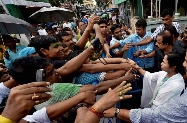 West Bengal CM Mamata Banerjee shaking hands with supporters after her party's thumping win. (PTI) West Bengal CM Mamata Banerjee shaking hands with supporters after her party's thumping win. (PTI)