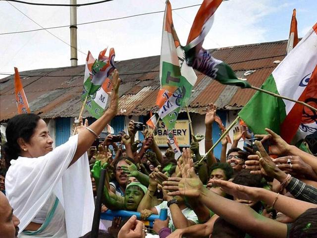 West Bengal CM Mamata Banerjee waves at supporters after her party's thumping win in West Bengal Assembly elections in Kolkata.  (PTI) 