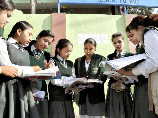 12th standard students give a last look to their notes as they prepare to appear in their CBSE exams at an examination centre in Moradabad .(PTI file photo)