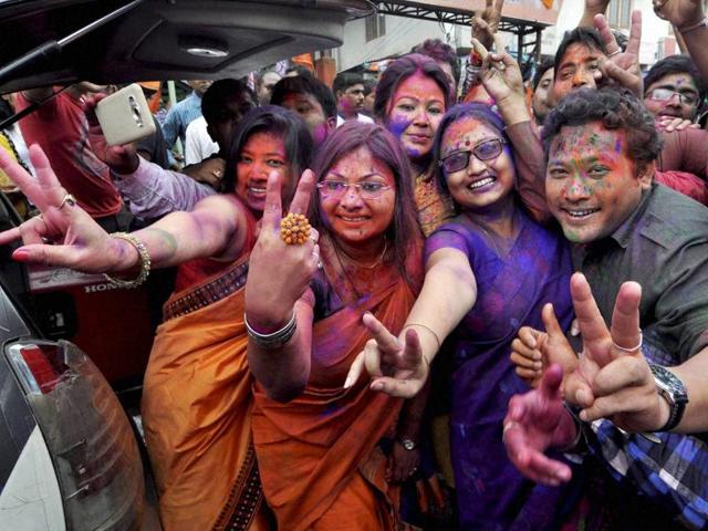 BJP workers dance as they celebrate their party’s victory in the Assam assembly elections, in Guwahati on Thursday.(PTI)