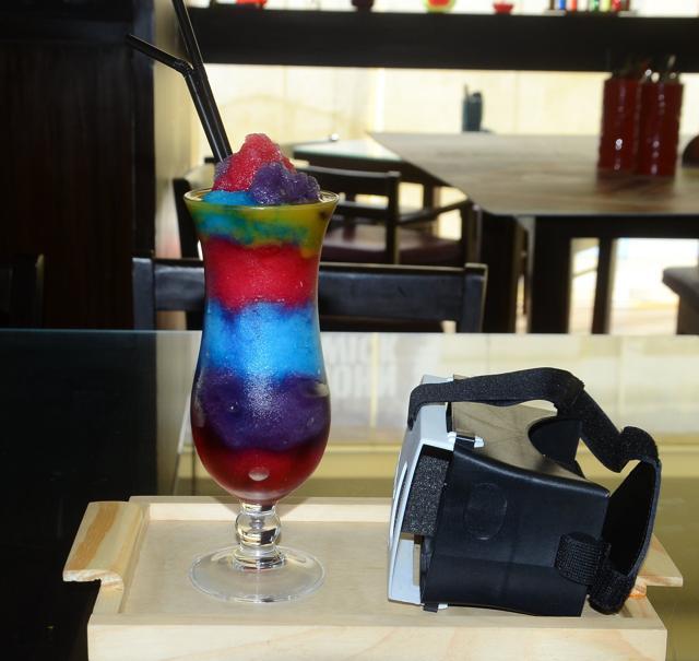 One heavily sold drink has people wearing a virtual reality headset while slurping on Guardian of the Galaxy, a cloying cocktail with slushy layers of blue curaçao, grenadine, vodka, triple sec, and lime juice churned so it looks like a NASA image. The drink is as bad as the concept is good. (Shakti Yadav/ HT Photo)