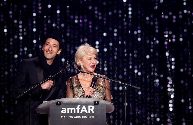 Actors Adrien Brody and Helen Mirren conduct an auction during the amfAR's Cinema Against AIDS 2016 event during the 69th Cannes Film Festival in Antibes, near Cannes. (REUTERS)